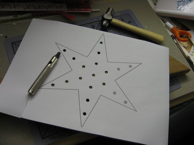 Punching the LED holes in the Christmas Star.